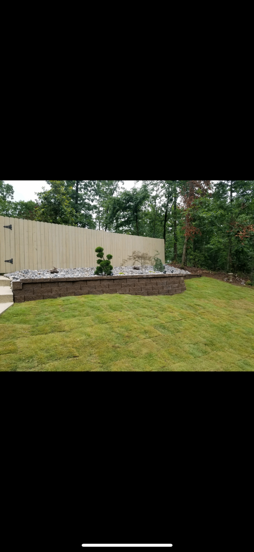 Low garden retaining wall with decorative landscaping